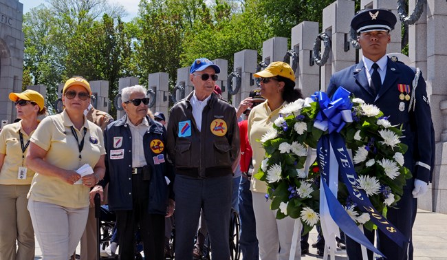 A group prepares to lay a wreath at the World War II Memorial