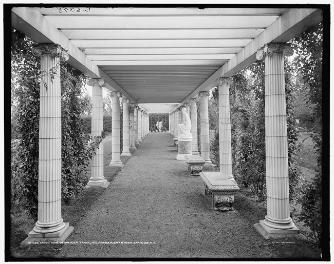View along the pergola with columns lining a walkway