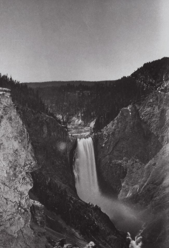 Black and white image of a large waterfall.