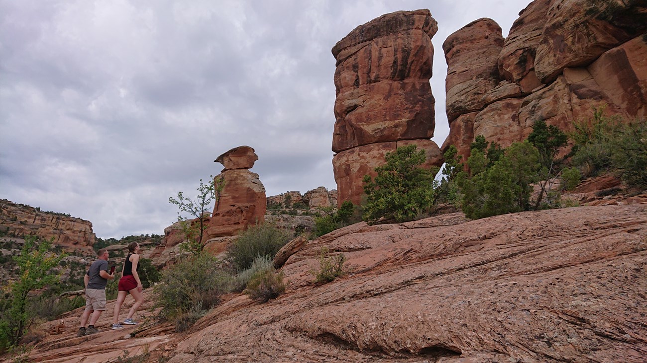 A father and daughter admire sandstone formations.