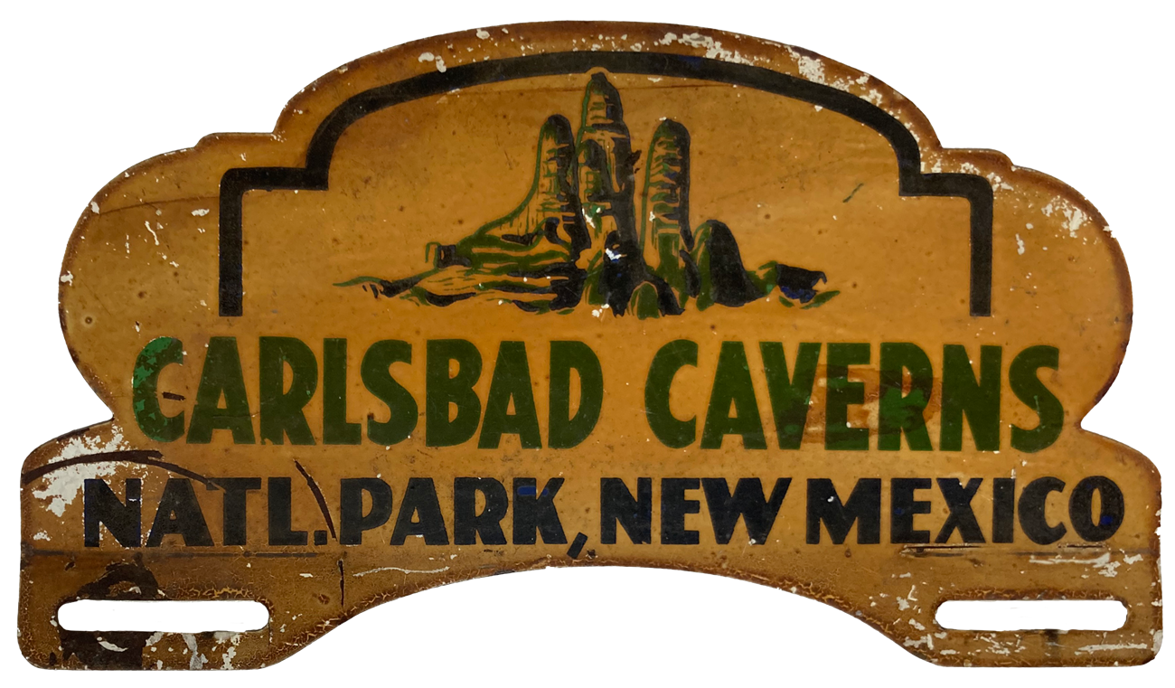 Metal plate with stalagmites and Carlsbad Cave painted on it