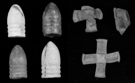 Four cylindrical bullets on the left. On the right are two cross-shaped and one cap-shaped, used percussion cap.