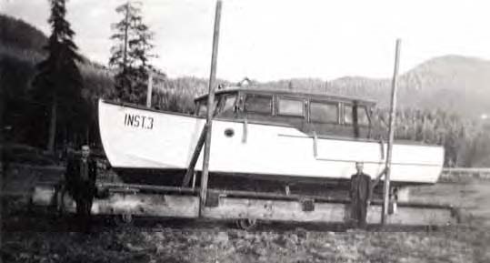 Black and white photo of a boat with writing "INST. 3" on bow