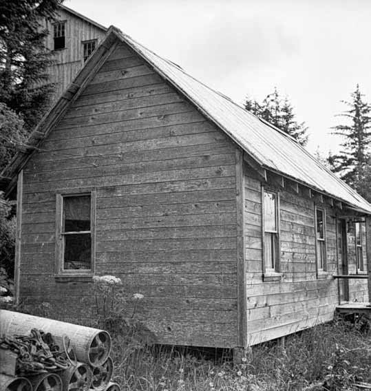 Black and white photo of a wood framed building.