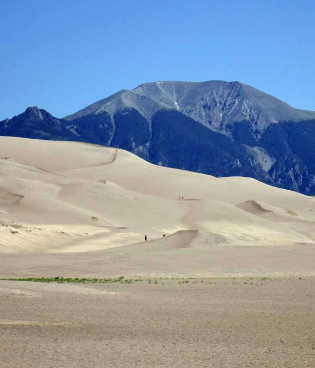 sand dunes with mountains beyond