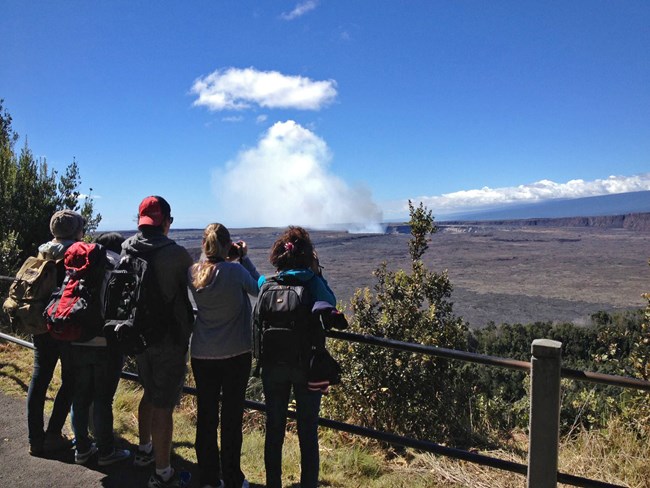 Visotors watch a steam plume from the Jagger Visitor center at Hawaii Volcanoes NP