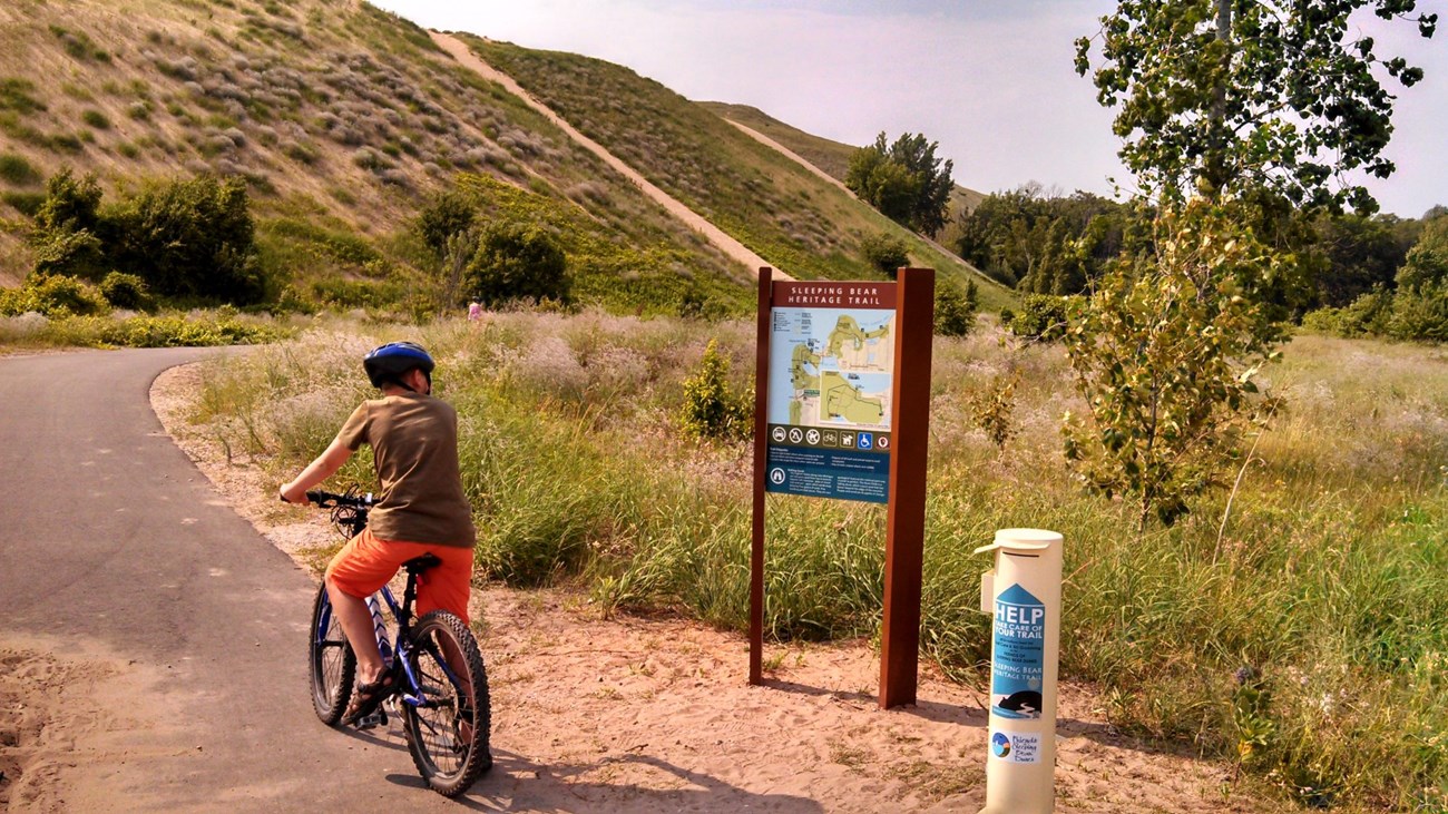 A cyclist checks out a wayfinding sign along the Heritage Trail.