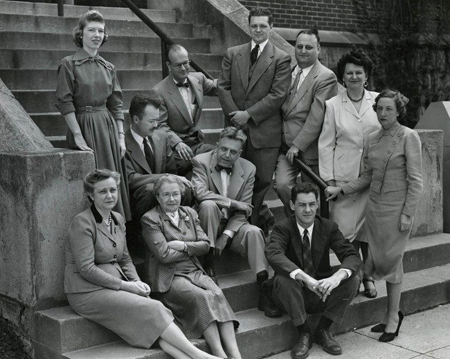 A group of people posed on steps for a photo. From Collections of the Smithsonian Institution Archives