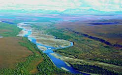 Kugururok River with south slope of Brooks Range in background, Noatak National Preserve. Series of vegetated river terraces to north of Kugururok River are study sites.
