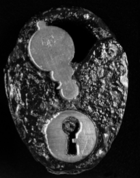Oval-shaped padlock with rough, bumpy texture. It has a metal keyhole on the bottom and and keyhole cover above.