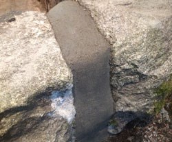 dark grey mortar in granite crack
