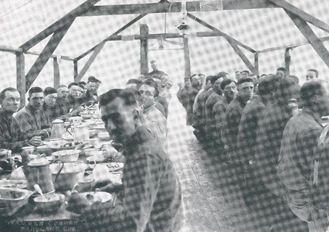 SPD soldiers sit at a table and eat a meal