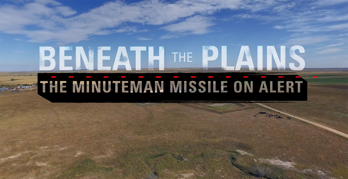 A building on a prairie landscape with superimposed titles in front of it