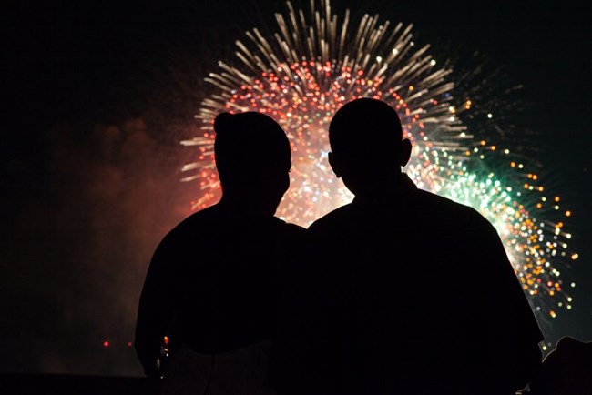 Silhouette of President and first lady Obama looking at fireworks.