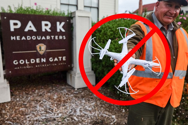 A man in an orange vest holds a quadcopter. A circle with a slash overlays the quadcopter.