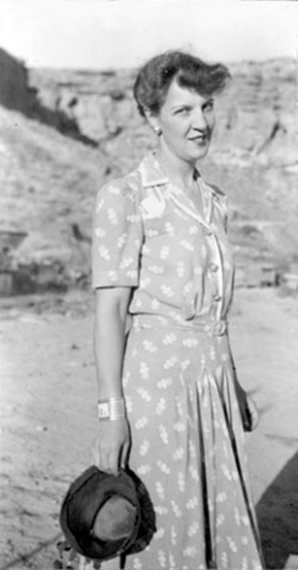 Florence Hawley Ellis wearing a dress and smiling at Chaco Canyon in 1940. National Park Service.