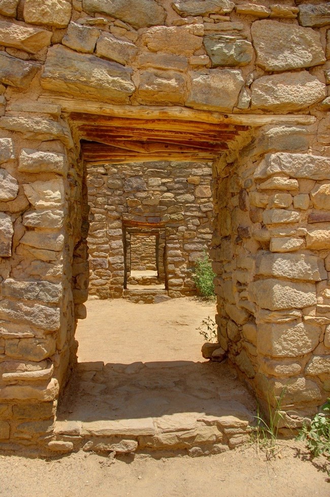 A series of doorways built in sandstone walls.