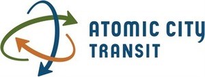 Atomic City Transit in blue lettering with a stylized atom symbol in blue, orange, and green.