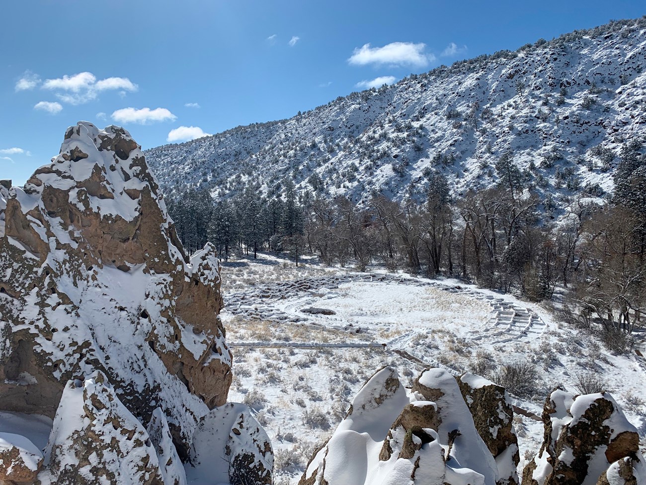 An aerial view of a snow covered stone foundation.