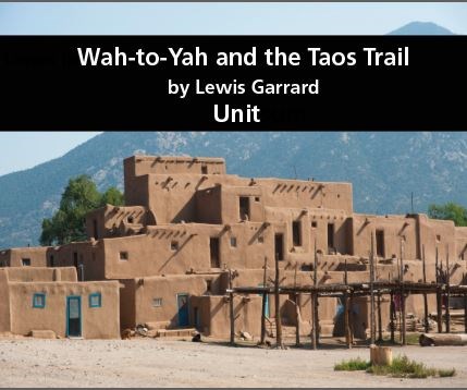 Photo of Taos Pueblo in New Mexico with mountains in the background