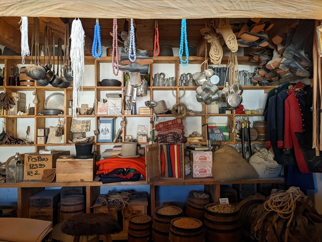 photo of 1800s trade room with trade goods on shelves and counter