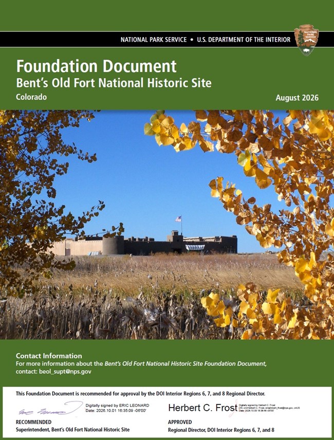 A document cover with green background and white text features a picture of the replica fort and autumn leaves