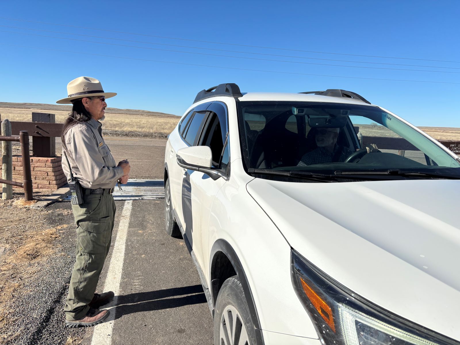 Ranger greets visitor at parking entrance gate