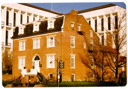 Three story brick federal style house with Hart Senate Office building in background