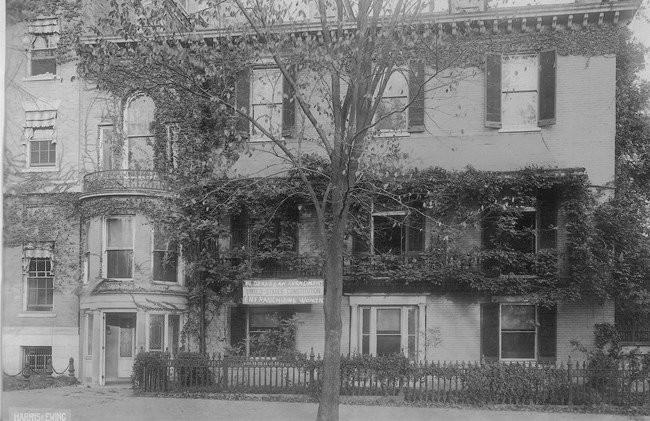 Front of Cameron House with curved portico at front entrance and second floor terrace
