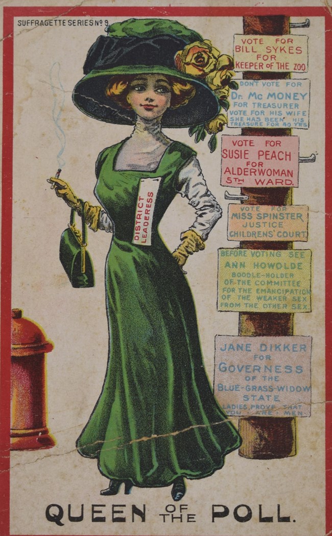 Postcard with a color an illustration of well-dress woman wearing a "District Leaderess" ribbon. She is standing next to a pole with a series of campaign signs for female candidates.