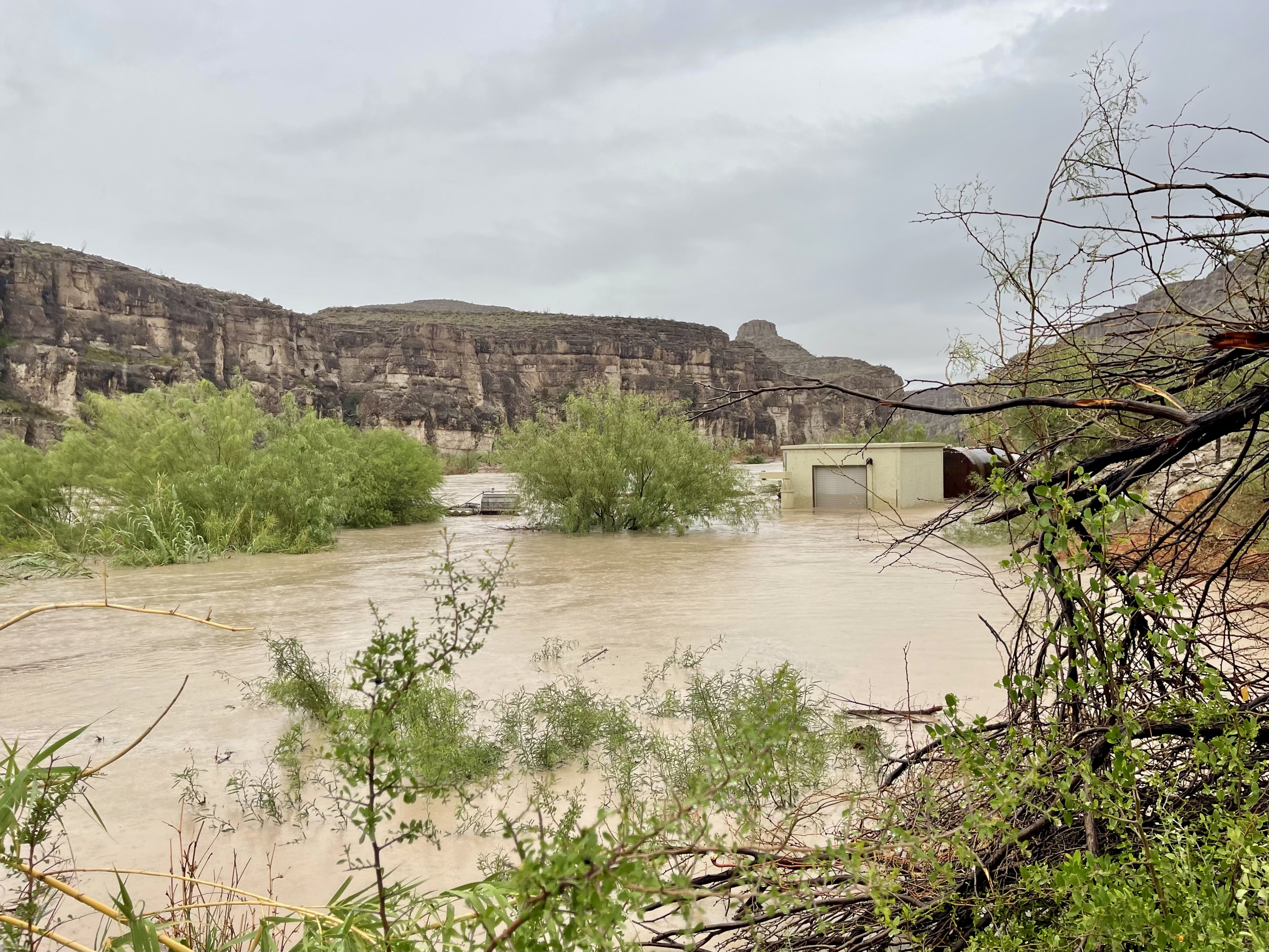 A building is almost submerged beneath flood waters.