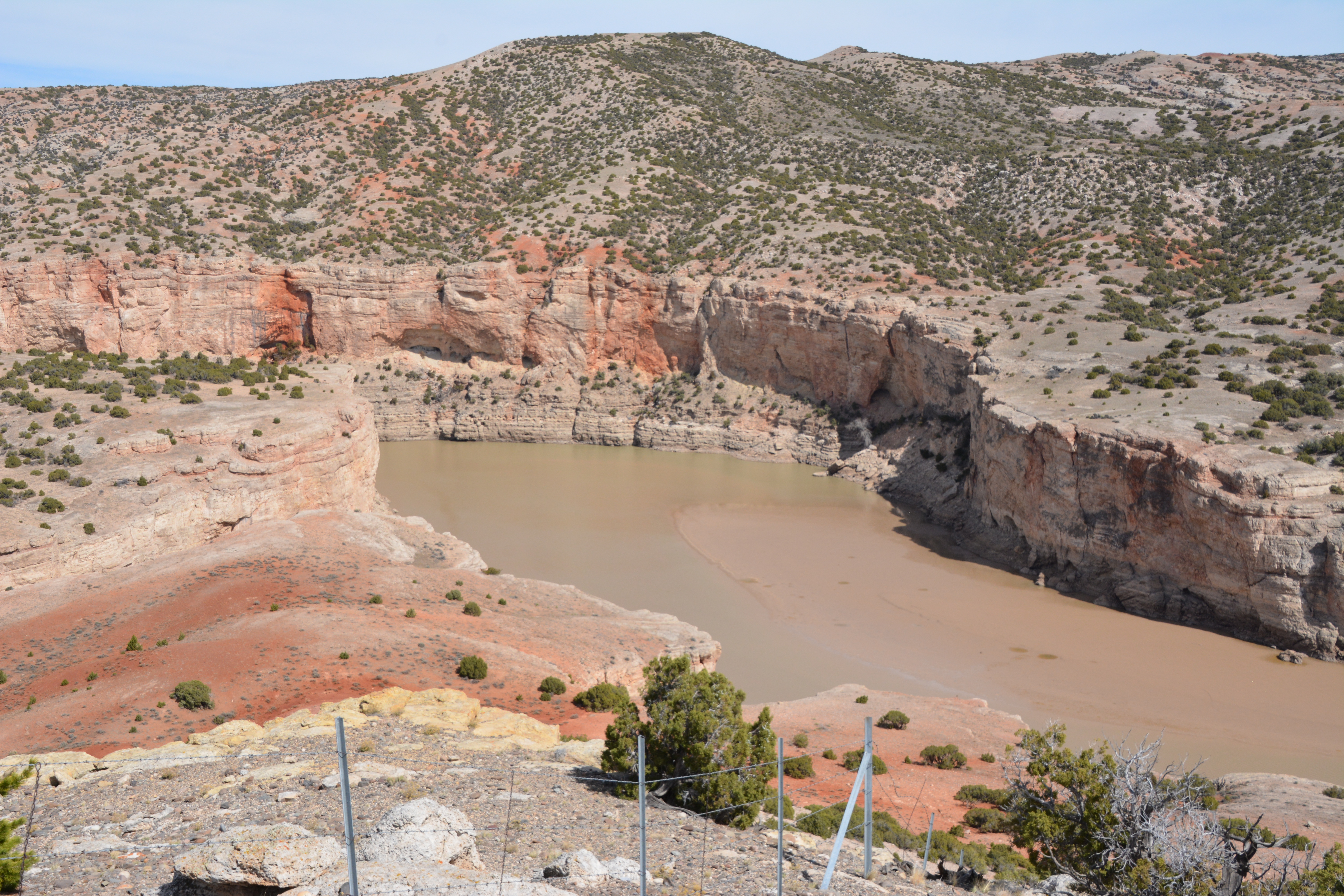 Looking down into Bighorn Canyon at a red sand bar revealed by low water levels.