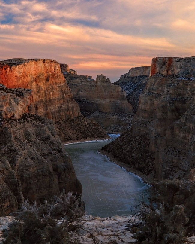 Sunset over Bighorn Canyon with frozen water at the bottom.