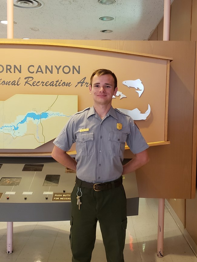 Park Ranger standing before a display