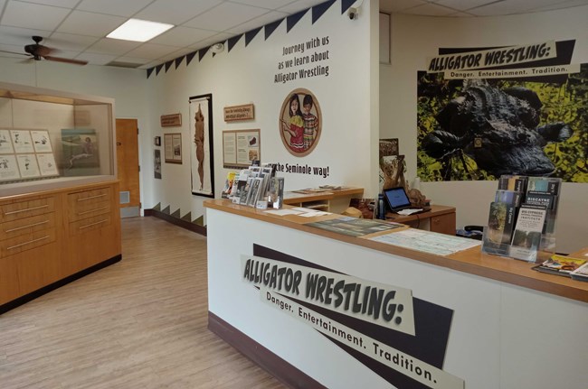 The inside of Oasis Visitor Center with the Alligator Wrestling exhibit on the walls