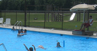 kids in pool with lifeguard nearby