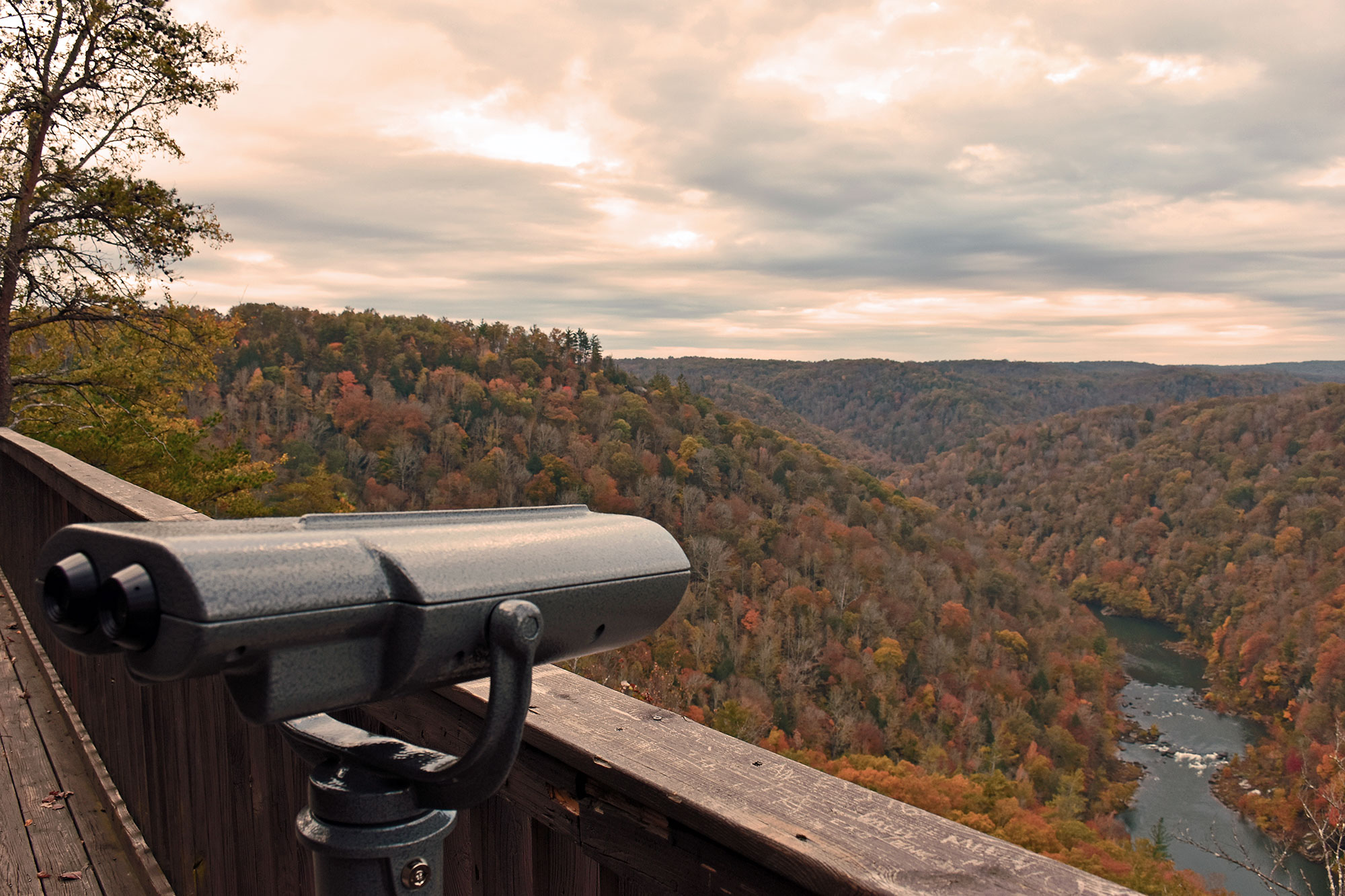 Viewfinder points over the overlook towards the river and multi-colored forests below