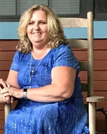 A female sitting down in a rocking chair