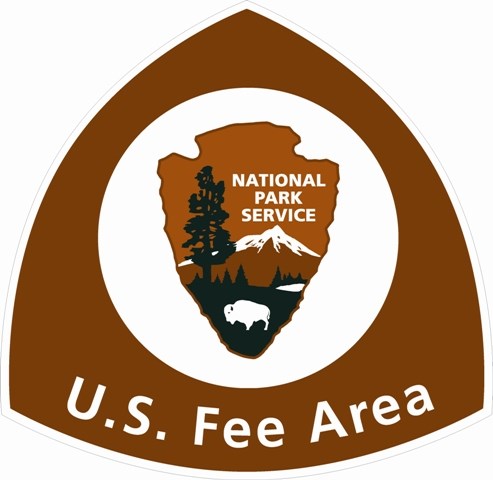 US Fee Area sign with arrowhead in center