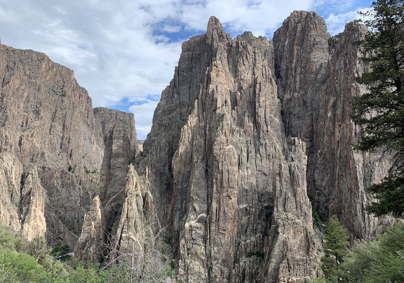 Rock pillars loom overhead from view within canyon