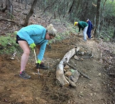 Trail volunteers working to restore a trail.