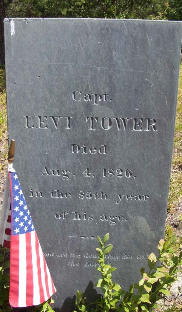 a historic grave with american flag beside it