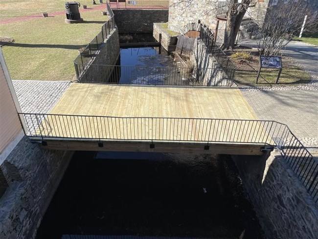 Wooden bridge across waterway