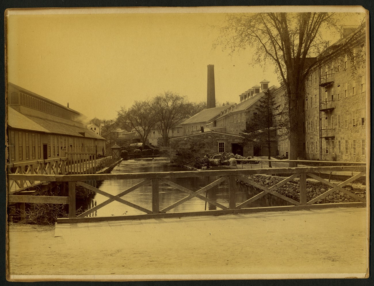 Picture of mill raceway surrounded by industrial buildings. All buildings part of the Western Mill complex