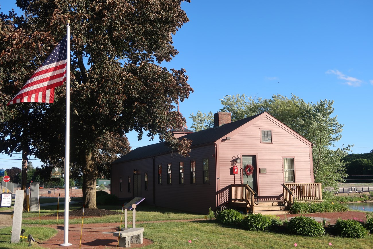 Small red structure with American flag in foreground