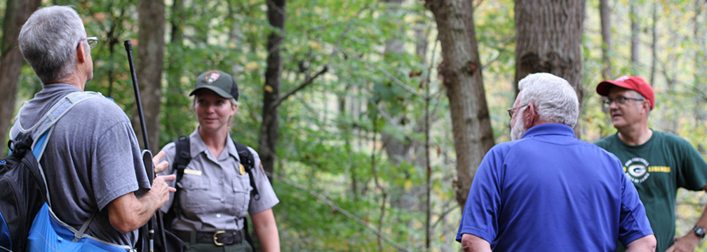 ranger with visitors on a trail