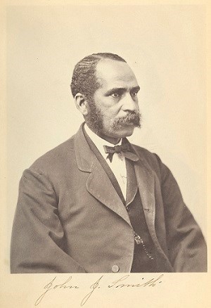 portrait of mustached African American man wearing a three piece suit