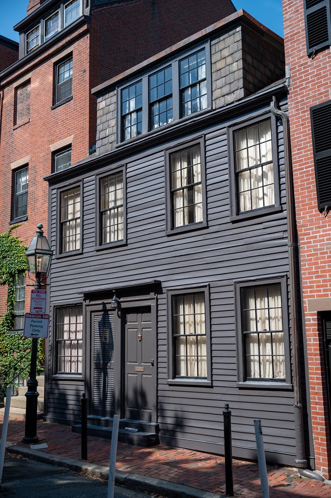 A two story house that is painted gray