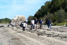 Blue Crew volunteers pick up trash off the beach