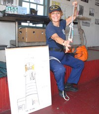 U S Coast Guard Auxiliary member ties a knot.